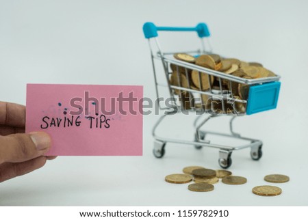 Financial concept. Gold coins and shopping cart on white background.