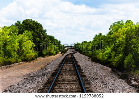 Railroad track on a country backroad.