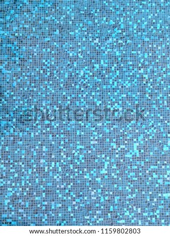 Blue tiles of swimming pool background. Overhead view.