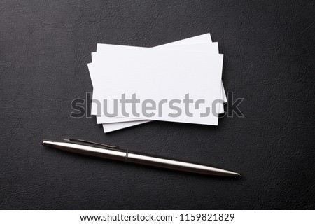 Blank business cards on workplace table. Top view with space for your text
