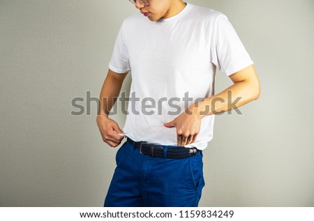 Man tucking t-shirt in the pant