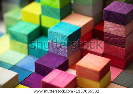 Spectrum of stacked multi-colored wooden blocks. Background or cover for something creative, diverse, expanding,  rising or growing. 