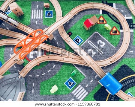 Road traffic with wooden toy cars in the town on white background, safety and traffic regulations concept, backgrounds. Transportation system concept. Play set of road signs. Scale model on the road.