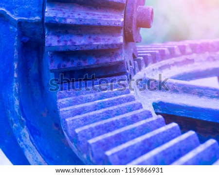 Oblique gear in blue and pink shade it is a components parts of industrial machinery ,this image in industrial and machinery concept