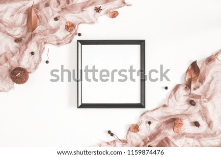 Autumn composition. Photo frame, textile, dried flowers and leaves on white background. Autumn, fall concept. Flat lay, top view, copy space