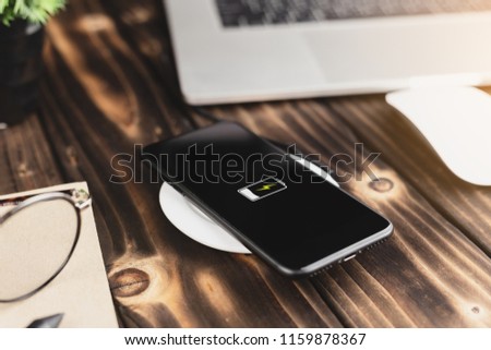 close-up phone charging on wireless charger device Royalty-Free Stock Photo #1159878367