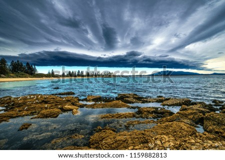 Heavy cloud Bermagui beach, the beach is practically in town in this part of the far south coast of NSW Australia, the town is known for great game fishing swimming and holidays.