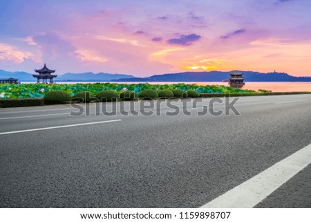 Empty asphalt road and natural landscape in the setting sun