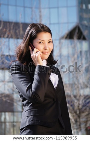 Portrait of a cute business woman over business center on back