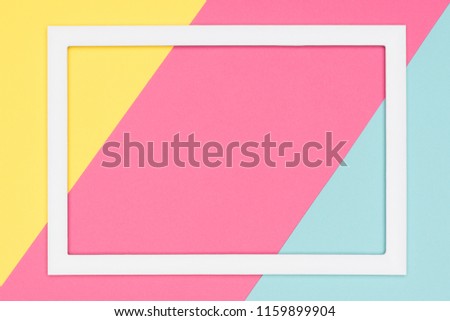 Abstract geometrical pastel blue, yellow and pink paper flat lay background. Minimalism, geometry and symmetry template with empty picture frame mock up.