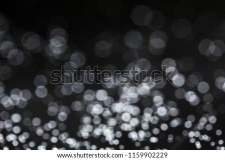 White bokeh and black background can be used for designing images.