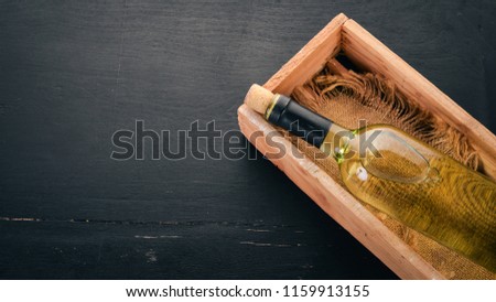 A bottle of white wine. Wine. Top view. On a black background. Free space for text.