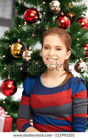 bright picture of happy and smiling woman with christmas tree...
