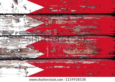 National flag of Bahrein on a dull wooden background