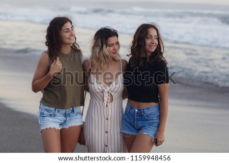 Summer holidays and vacation concept- girls walking on the beach