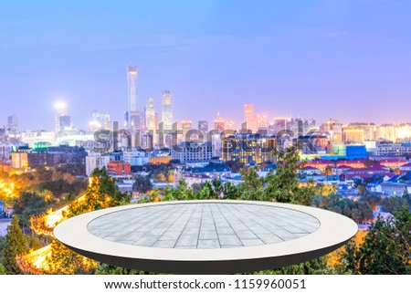 Empty square floor and modern city skyline in Beijing at night