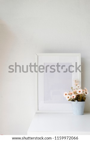 Photo frame and flower on table with copy space.
