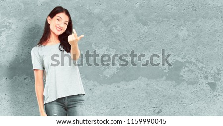 young pretty girl full body smiling with a proud, satisfied and happy look, making a gesture as if accepting a challenge, confident of success.