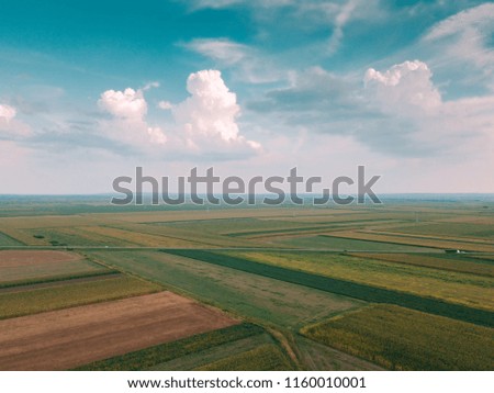 Beautiful idyllic aerial shot of countryside plain landscape in summer afternoon