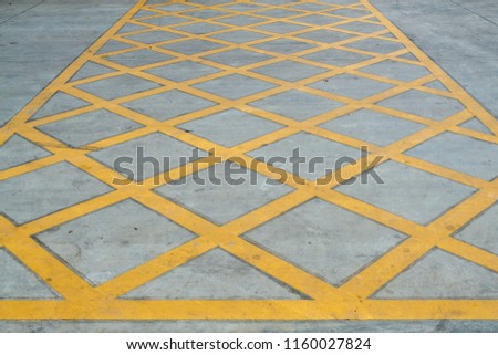 Yellow box or Cross yellow line sign marking on the road for no parking area