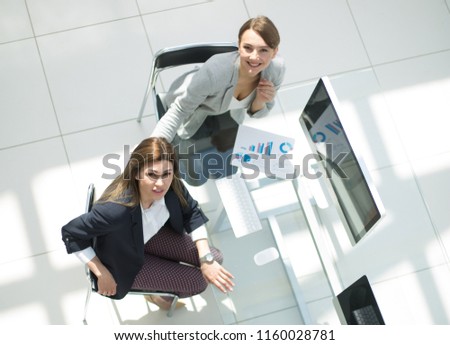 top view.business team sitting at the Desk and looking at the camera