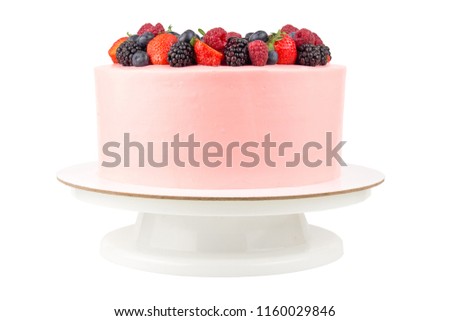 Cake with whipped pink cream, fresh strawberries, blueberries, blackberry and raspberry on white background. Isolated. Picture for a menu or a confectionery catalog.
