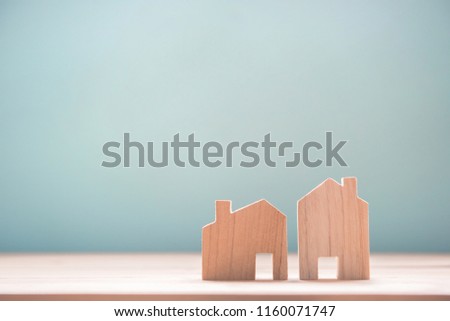 Close up diffirance two wood house model on blue background, Choose home the best for you, Planning to buy property.