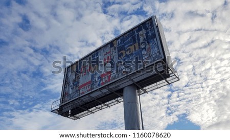 Billboard on blue sky background with white clouds