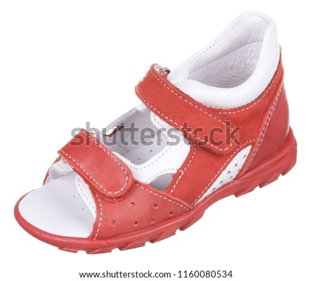 Side upper view of orange red and white suede and leather girl sandal with slits and holes and two velcros, isolated on white
