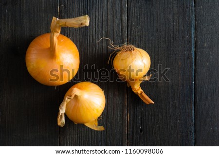 onions on old black wooden table background