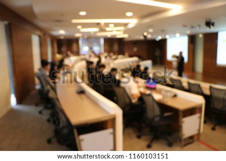 Blur Picture of conference room with presentation on report