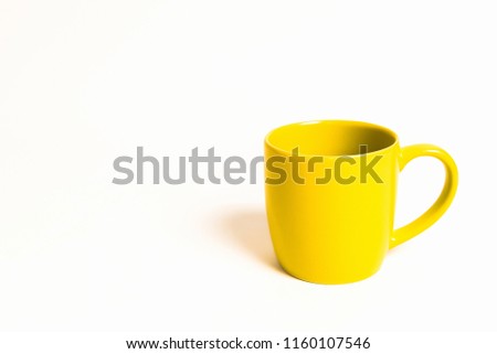 Yellow cup of coffee isolated on white background.