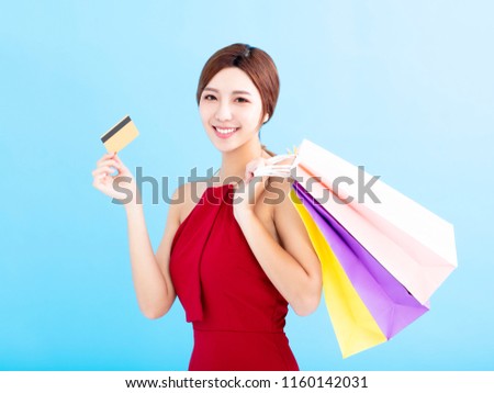 young woman with shopping bags and showing  credit card 