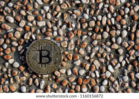 Cryptocurrency symbol electronic sign, focus on gold metal Bitcoin stack on small stone background copy space. Concept of transfer or exchange digital money through blockchain.

