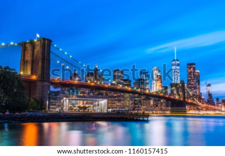 brooklyn bridge with new york skyline background at night.