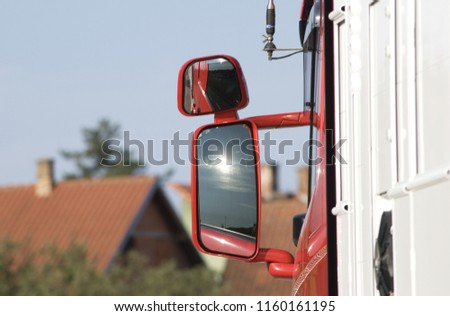 the reflection of the sun on the rear view mirror of the truck Royalty-Free Stock Photo #1160161195