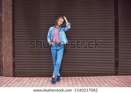Blonde girl smiling on a striped  background ..
