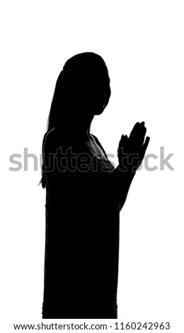 silhouette of a girl who stands in a pensive posture