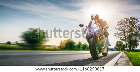 motorbike on the road riding. having fun driving the empty road on a motorcycle tour journey. copyspace for your individual text. Royalty-Free Stock Photo #1160250817