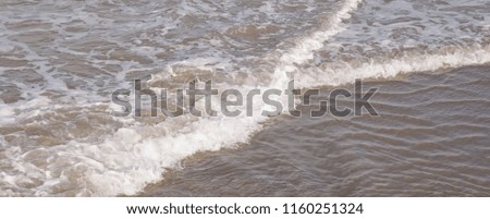 Close up of ocean water running over sand on a beach