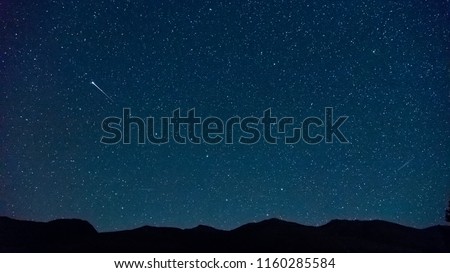 Shooting star (Perseids meteor shower) near the Big Dipper (Plough), with Ursa Minor and north star visible, Zuoz, Engadine, Switzerland. Royalty-Free Stock Photo #1160285584