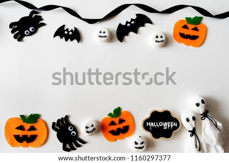Top view of Halloween crafts, orange pumpkin, ghost and spide on white background with copy space for text. halloween concept.