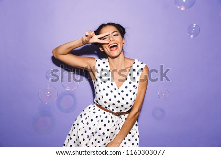 Portrait of a smiling young woman in summer dress isolated, having fun