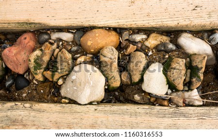 Stones trapped in a coastal groyne