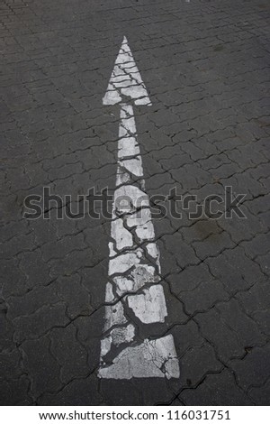 white arrow marking on road
