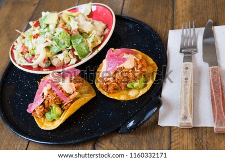 Closeup of mexican food, salad with chicken, avocado and tuna tostada