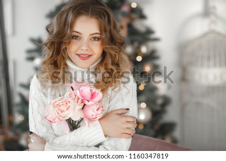 Close up portrait of young beautiful woman on Christmas background