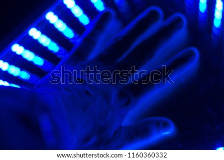 hand in blue halogen light