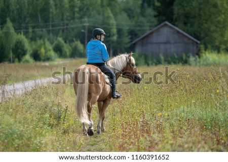 Woman horseback riding on country