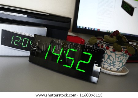 Electronic clock with large display and built-in radio.